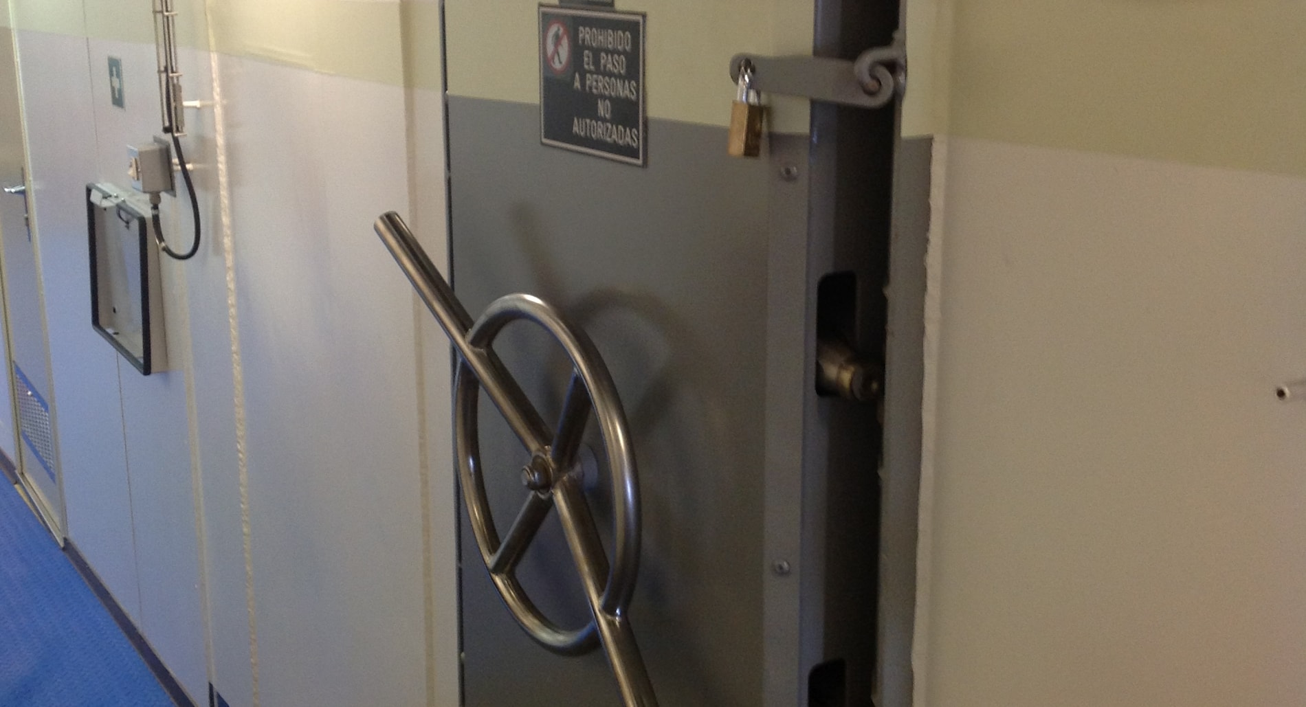 Puerta estanca cerrada instalada a bordo de un buque, con el volante de cierre abierto